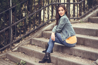 Young woman sitting on staircase