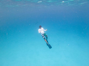 Low section of woman swimming in sea