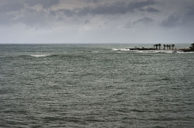 Scenic view of sea against cloudy sky