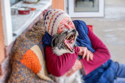 Close-up of dog wearing hat on snow