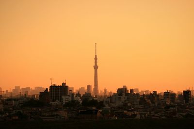 Tokyo sky tree against sky during sunset in city