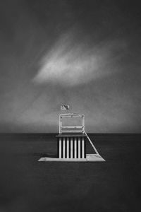 Lifeguard hut on beach against sky