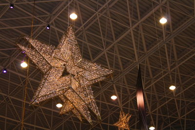 Low angle view of illuminated star lantern hanging from ceiling