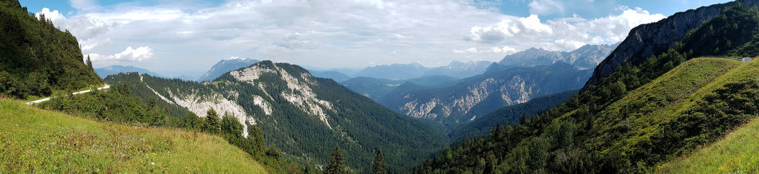 Scenic view of mountains against cloudy sky