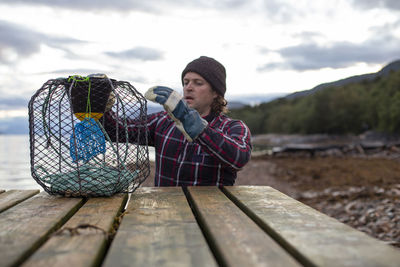 A norwegian fisherman inspects his crab pot