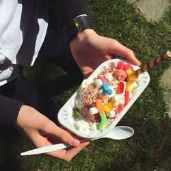 Close-up high angle view of hands holding sweet food