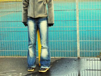 Low section of woman standing on tiled floor