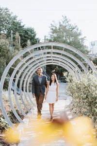 Young couple walking in covered walkway at park