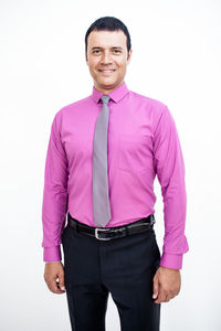 Portrait of a smiling man standing against white background