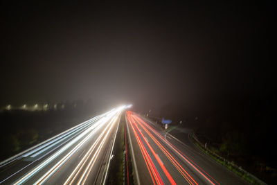 High angle view of light trails on road at night