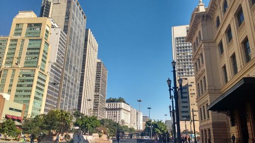 Low angle view of buildings against blue sky