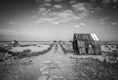 Dirt road passing through field