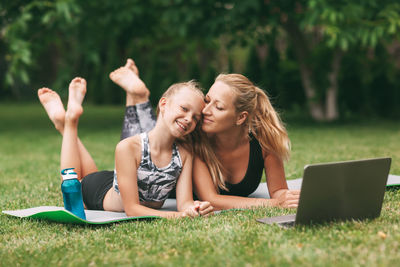 Woman using mobile phone on grass