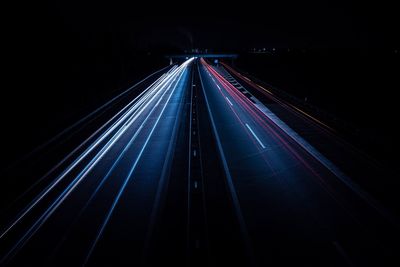 High angle view of light trails on highway at night