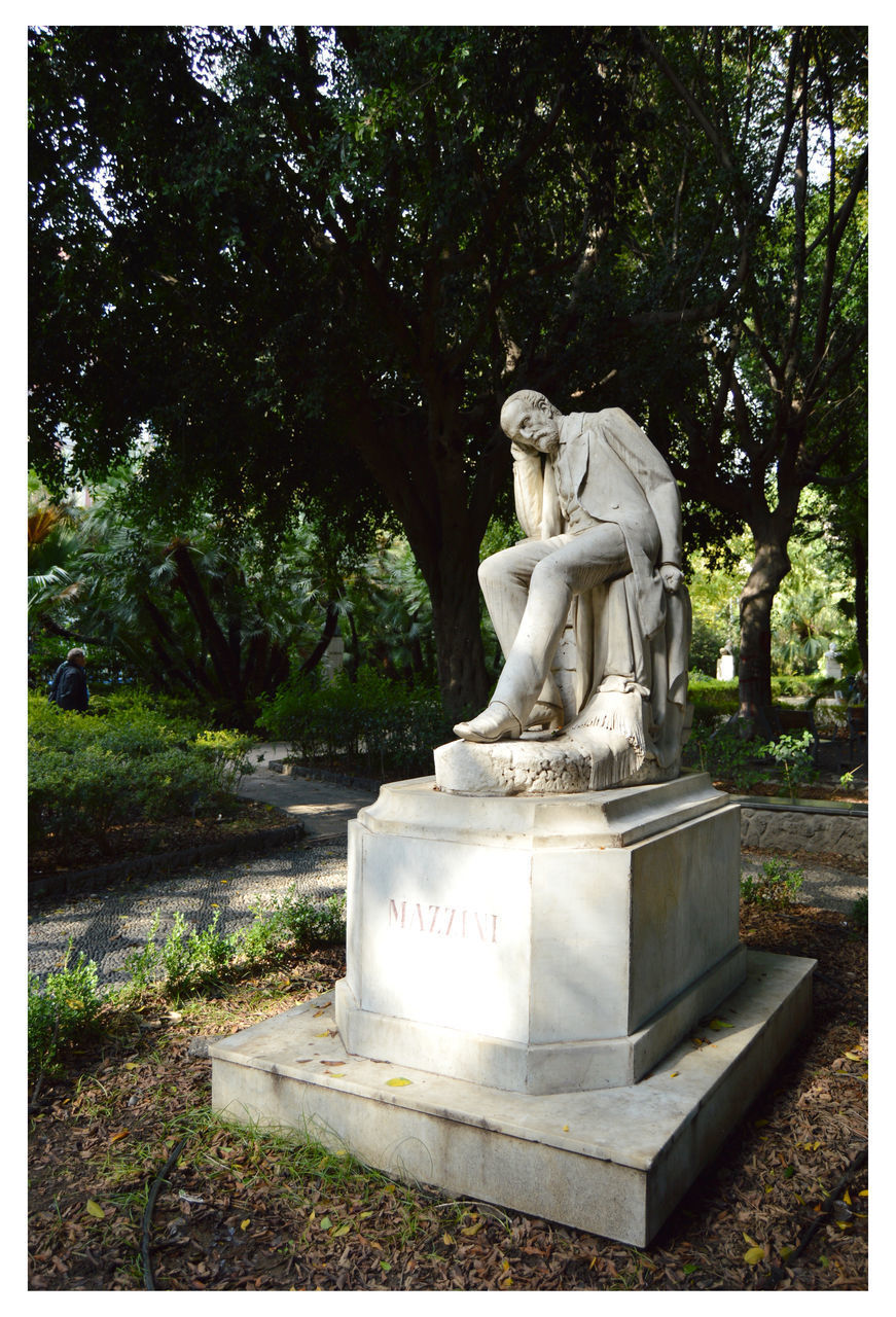 STATUE AGAINST TREE