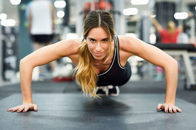 Portrait of woman exercising in gym