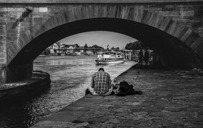 Two people relaxing by a a river