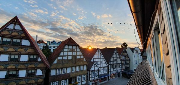 Low angle view of buildings against sky during sunset