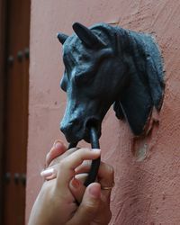 Close-up of person hand holding sculpture