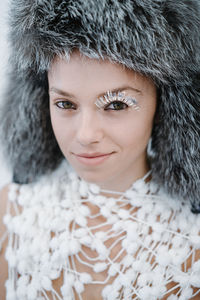 Close-up portrait of beautiful young woman in fur hat 