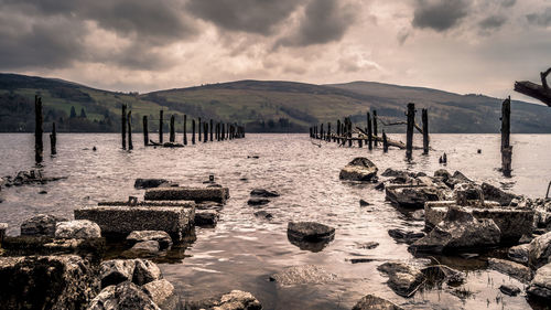 Panoramic view of wooden posts against sky