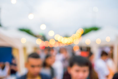 Defocused image of people in illuminated city