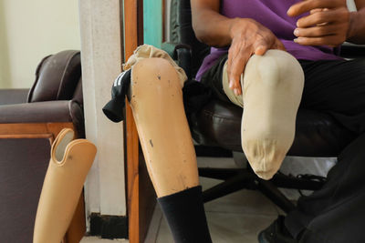 Low section of man sitting on seat