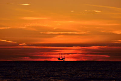 Scenic view of sea against orange sky