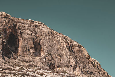 Low angle view of rock formation against sky