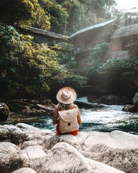 Rear view of man looking at waterfall