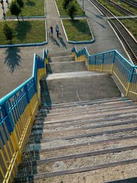 High angle view of staircase at park by railroad tracks