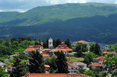 View of townscape by mountain against sky