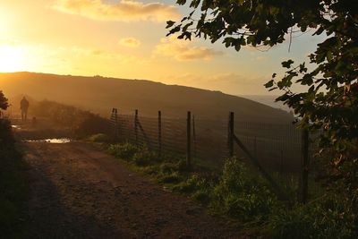 Scenic view of landscape against sky at sunset