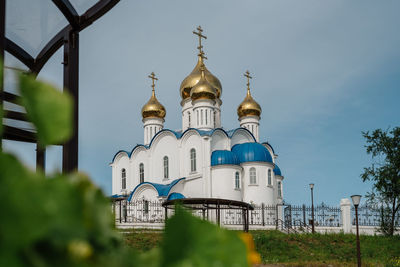Low angle view of church and building against sky