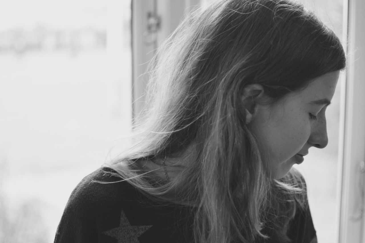 long hair, headshot, focus on foreground, young women, young adult, lifestyles, person, close-up, brown hair, human hair, leisure activity, contemplation, side view, human face, medium-length hair, head and shoulders