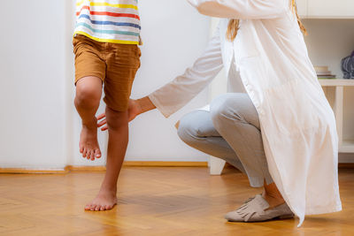 Physical therapist doing medical exam with a boy. balance test.