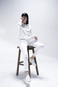 Young woman sitting on snow