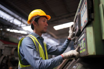 Rear view of man working at construction site