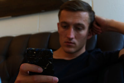 Portrait of young man using mobile phone