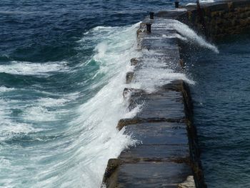 High angle view of waves splashing on sea