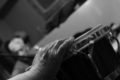 Cropped hand of man playing drum