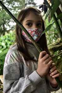 Portrait of cute girl holding plant