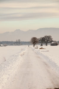 Scenic view of snow covered land against sky