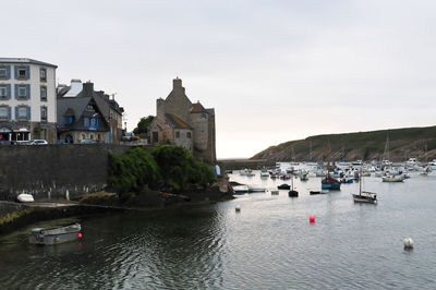 Panoramic view of buildings by sea against sky