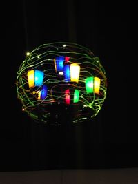 Low angle view of illuminated lights at night