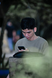 Side view of young man standing outdoors