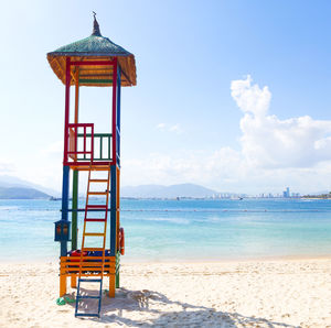 Lifeguard hut on beach against sky