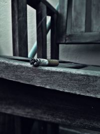 Close-up of cigarette on wood