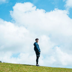 Man standing on field against sky