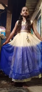 Full length of woman standing against wall